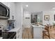 Open-concept kitchen with a center island and stainless steel appliances at 800 Savannah Ridge Rd # 109, Holly Springs, NC 27540