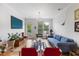 Bright living room with ample sunlight, a balcony, and comfortable seating, perfect for enjoying the view at 800 Savannah Ridge Rd # 109, Holly Springs, NC 27540