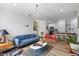 Bright living room offering seamless flow to the kitchen, a cozy seating arrangement, and modern lighting fixtures at 800 Savannah Ridge Rd # 109, Holly Springs, NC 27540