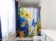 Charming bathroom with vanity, floral shower curtain, and blue and yellow accents at 8001 Strawberry Meadows St, Raleigh, NC 27613