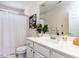 Clean bathroom with a white vanity, ample counter space, and a shower with a white curtain at 8001 Strawberry Meadows St, Raleigh, NC 27613
