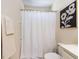 Bright bathroom featuring a white shower curtain, and white fixtures at 8001 Strawberry Meadows St, Raleigh, NC 27613