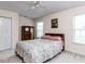 Cozy bedroom featuring a patterned bedspread, wood furniture, and natural light from the windows at 8001 Strawberry Meadows St, Raleigh, NC 27613