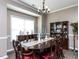 Elegant dining room with a dark wood table, chandelier, and buffet at 8001 Strawberry Meadows St, Raleigh, NC 27613