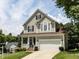 Beautifully landscaped two-story home with a covered front porch and attached two-car garage at 8001 Strawberry Meadows St, Raleigh, NC 27613