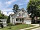 Charming two-story home with a well-manicured lawn and a welcoming front porch at 8001 Strawberry Meadows St, Raleigh, NC 27613