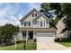 Charming two-story home with a manicured lawn, covered porch and a two car garage at 8001 Strawberry Meadows St, Raleigh, NC 27613