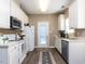 Bright kitchen with white cabinets, stainless steel appliances, and ample counter space at 8001 Strawberry Meadows St, Raleigh, NC 27613