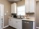 Bright kitchen with white cabinetry, stainless steel dishwasher, and natural light from the window above the sink at 8001 Strawberry Meadows St, Raleigh, NC 27613