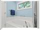 Clean bathroom features a tiled bathtub, modern fixtures, and a large window for natural light at 805 N Columbia St, Chapel Hill, NC 27516