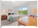 Bright bedroom with a work desk and a large window with views of mature trees at 805 N Columbia St, Chapel Hill, NC 27516