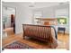 Spacious bedroom featuring hardwood floors, two windows, and a ceiling fan at 805 N Columbia St, Chapel Hill, NC 27516
