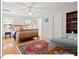 Sunlit bedroom with hardwood floors, ceiling fan, and windows at 805 N Columbia St, Chapel Hill, NC 27516