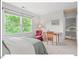 Sunlit bedroom with large window overlooking lush greenery, complemented by cozy furnishings at 805 N Columbia St, Chapel Hill, NC 27516