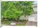 View of the home's exterior and attached garage, framed by mature shade trees at 805 N Columbia St, Chapel Hill, NC 27516
