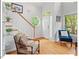 Bright foyer with hardwood floors, staircase and round window bringing in natural light at 805 N Columbia St, Chapel Hill, NC 27516