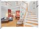 Open-concept living room featuring hardwood floors, a staircase, and a view into the dining area at 805 N Columbia St, Chapel Hill, NC 27516
