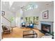 Bright living room featuring hardwood floors, fireplace, and large windows at 805 N Columbia St, Chapel Hill, NC 27516