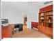 Home office space with hardwood floors, built-in shelving, and bright red accent wall at 805 N Columbia St, Chapel Hill, NC 27516