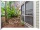 Screened porch with views of a landscaped yard filled with rocks and native plants at 805 N Columbia St, Chapel Hill, NC 27516