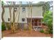 View of the rear exterior of the home with a screened-in porch and mature landscaping at 805 N Columbia St, Chapel Hill, NC 27516