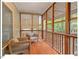 Relaxing screened porch, featuring wooden railings and a cozy seating area for outdoor enjoyment at 805 N Columbia St, Chapel Hill, NC 27516