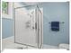 Tiled shower featuring glass doors, a rainfall showerhead, and sleek fixtures at 805 N Columbia St, Chapel Hill, NC 27516