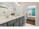 Bright bathroom featuring double sink vanity, white marble tile, and shower with glass door at 8217 White Star Dr, Fuquay Varina, NC 27526