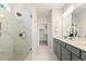 Bright bathroom featuring glass shower, and double sink vanity with gray cabinets at 8217 White Star Dr, Fuquay Varina, NC 27526