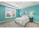 Brightly painted bedroom with carpet, a ceiling fan, and a large window overlooking a backyard at 8217 White Star Dr, Fuquay Varina, NC 27526