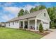 Charming single-story home boasts a manicured lawn, gray siding, and a cozy front porch at 8217 White Star Dr, Fuquay Varina, NC 27526
