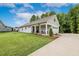 Beautiful single-story home showcasing lush landscaping and a covered front porch with seating at 8217 White Star Dr, Fuquay Varina, NC 27526