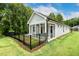Back exterior view of sunroom, fenced yard and well-manicured lawn at 8217 White Star Dr, Fuquay Varina, NC 27526