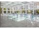 Stunning indoor pool featuring natural light through large windows and comfortable lounge seating at 8217 White Star Dr, Fuquay Varina, NC 27526