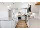 Open kitchen design features an island, modern appliances, and white cabinetry with granite countertops at 8217 White Star Dr, Fuquay Varina, NC 27526