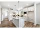 Modern kitchen featuring white cabinetry, granite countertops, and stainless steel appliances at 8217 White Star Dr, Fuquay Varina, NC 27526