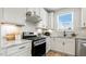 Bright, modern kitchen showcases stainless steel appliances, white cabinets, and an island at 8217 White Star Dr, Fuquay Varina, NC 27526