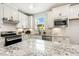 Beautiful kitchen features an island, white cabinets, stainless steel appliances and granite countertops at 8217 White Star Dr, Fuquay Varina, NC 27526