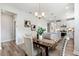 View of the kitchen and dining area, with the kitchen featuring white cabinetry and an island at 8217 White Star Dr, Fuquay Varina, NC 27526