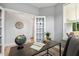 Office with wood floors, a modern desk, a globe, bright windows and French doors at 8217 White Star Dr, Fuquay Varina, NC 27526