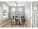 Office with wood floors, a modern desk, a globe, bright windows and French doors at 8217 White Star Dr, Fuquay Varina, NC 27526