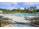 Large outdoor pool with plenty of lounge chairs and umbrellas for residents to enjoy a sunny day at 8217 White Star Dr, Fuquay Varina, NC 27526