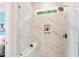 Shower with marble tile and glass door plus built in niche and bench at 8217 White Star Dr, Fuquay Varina, NC 27526