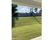 View of the expansive backyard featuring a lush lawn and a classic wooden fence, offering privacy at 8680 Kenridge Ln, Fuquay Varina, NC 27526