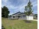 Charming single-Gathering home boasts stone accents, a manicured lawn, and a classic red front door at 8680 Kenridge Ln, Fuquay Varina, NC 27526