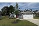 Charming one-story home with gray siding, stone accents, a red front door, and a well-manicured lawn at 8680 Kenridge Ln, Fuquay Varina, NC 27526