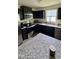 Well-equipped kitchen with black cabinets, stainless steel appliances, and granite countertops at 8680 Kenridge Ln, Fuquay Varina, NC 27526