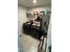 Organized laundry room with modern Samsung washer and dryer units and storage shelf at 8680 Kenridge Ln, Fuquay Varina, NC 27526