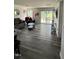 A cozy living room featuring wood floors, a sliding glass door to the backyard, and modern furniture at 8680 Kenridge Ln, Fuquay Varina, NC 27526