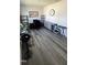 Office space with gray wood-look floors, a desk, and shelving units at 8680 Kenridge Ln, Fuquay Varina, NC 27526